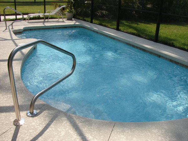 What considerations should be made when installing a glass pool fence in the UK?